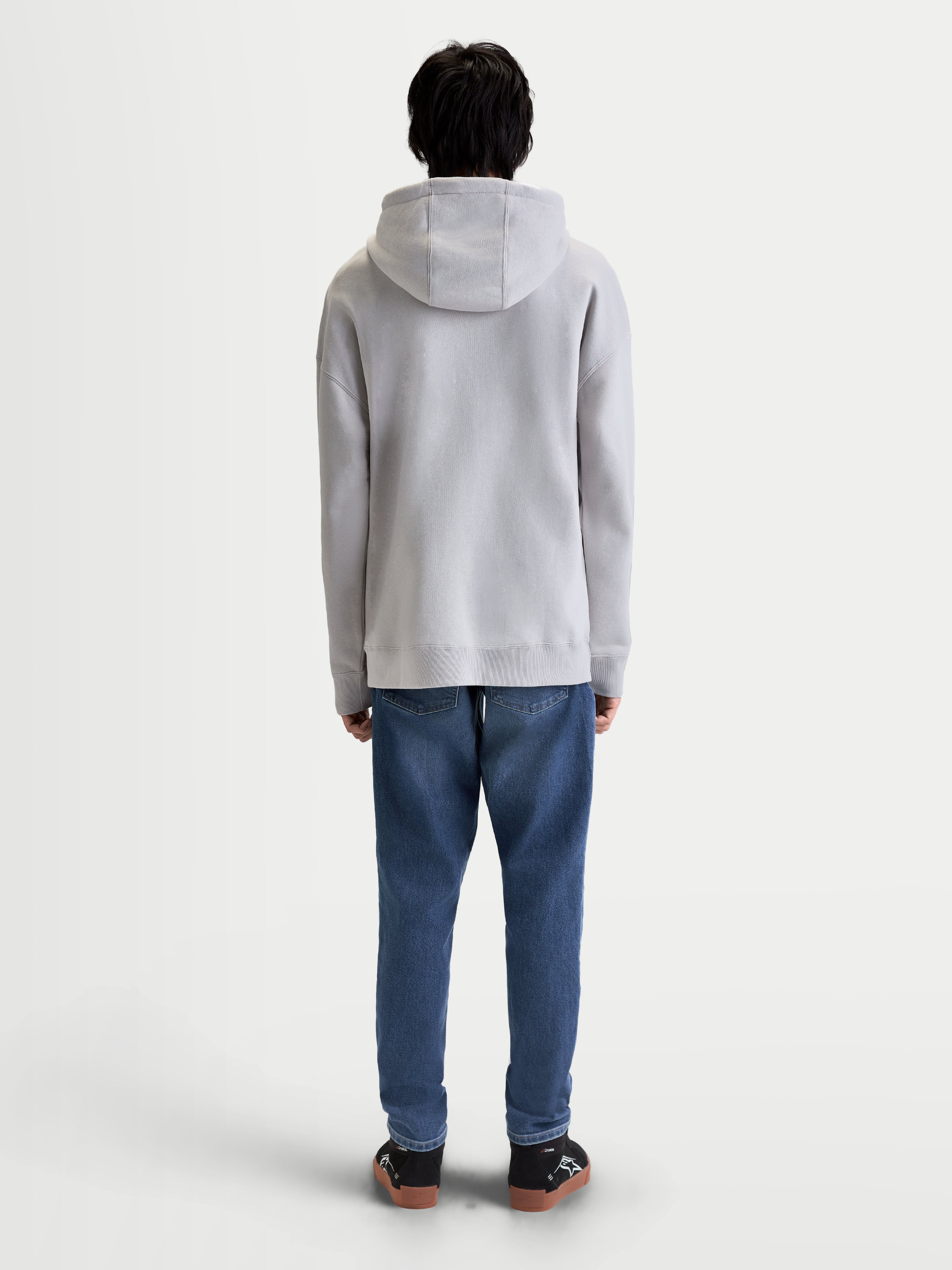 Alpinestars Prelude Oversized hættetrøje, grå sportswear fleece-pullover til herrer, set bagfra på model med afslappet pasform, selvforet hætte og ribmanchetter og ribkant.