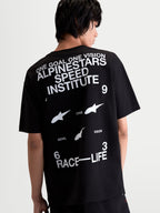 Alpinestars Institute Oversized CSF Tee, Black and White Sportswear T-Shirt, Rear View on Model showing 'Alpinestars Speed Institute' and 'Race-Life' back graphics, relaxed oversized fit, comfortable cotton-poly blend.