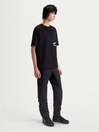 Alpinestars Institute Oversized CSF Tee, Men's Sportswear Short Sleeve T-Shirt in Black, featuring a relaxed oversized fit and white chest logo graphic, worn by a model for a casual motorsport-inspired look.