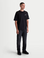 Alpinestars Mandate Oversized CSF T-shirt, kortærmet herre-sportstøj, sort med hvidt puff-print logo, afslappet oversized pasform, casual hverdagstøj vist på model