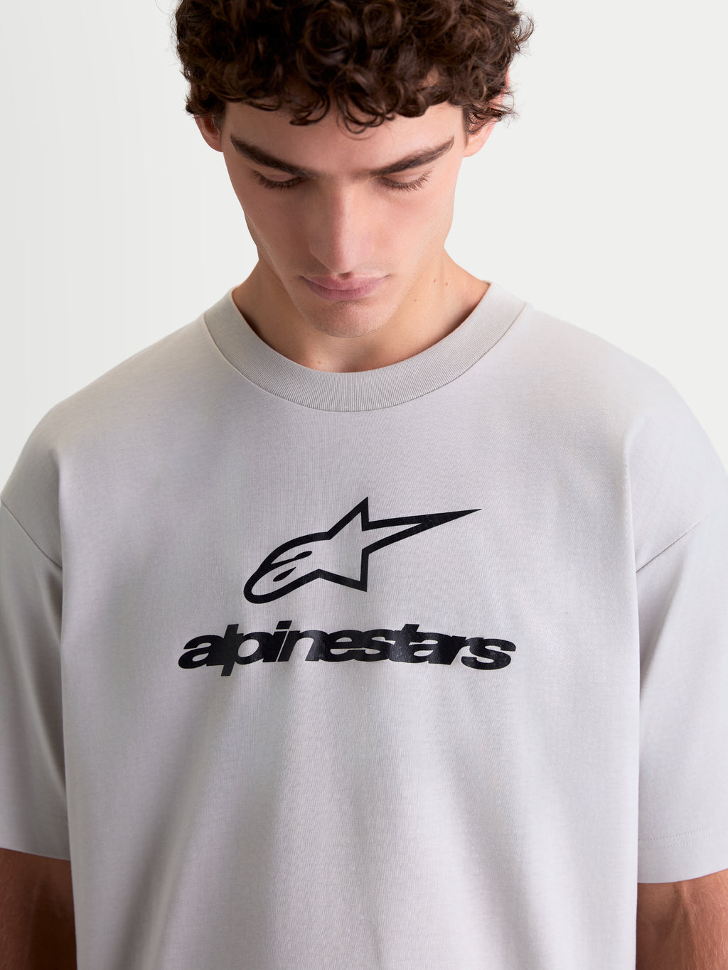 Alpinestars Prelude Oversized CSF Tee, Men's Sportswear Short Sleeve T-Shirt in Cement Gray, featuring a black soft hand-print Astars stacked logo on the chest, relaxed oversized fit, and comfortable cotton-poly blend construction for everyday casual wear.