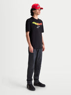 Alpinestars Elliptogrit CSF t-shirt, herre kortærmet sportstøj t-shirt, sort med gult og rødt gradient Astars-ordmærke og hvidt logografik, blød bomuld-polyesterblanding.