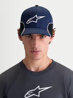 Alpinestars 500 Snapback kasket, sportswear kasket til herrer, navyblå og sort, buet skygge og struktureret krone med 3D-broderet Astars-logo og hvid kontrastpiping, set forfra på model.