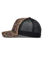 Alpinestars Thicket Realtree Trucker Hat, Camo and Black, with a curved bill and structured mesh back.
