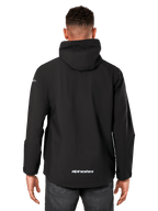 Alpinestars Kascade Rain Jacket, Men's Rain Shell, Black, Rear view showing fixed hood and Alpinestars logo on the lower back, casual waterproof sportswear