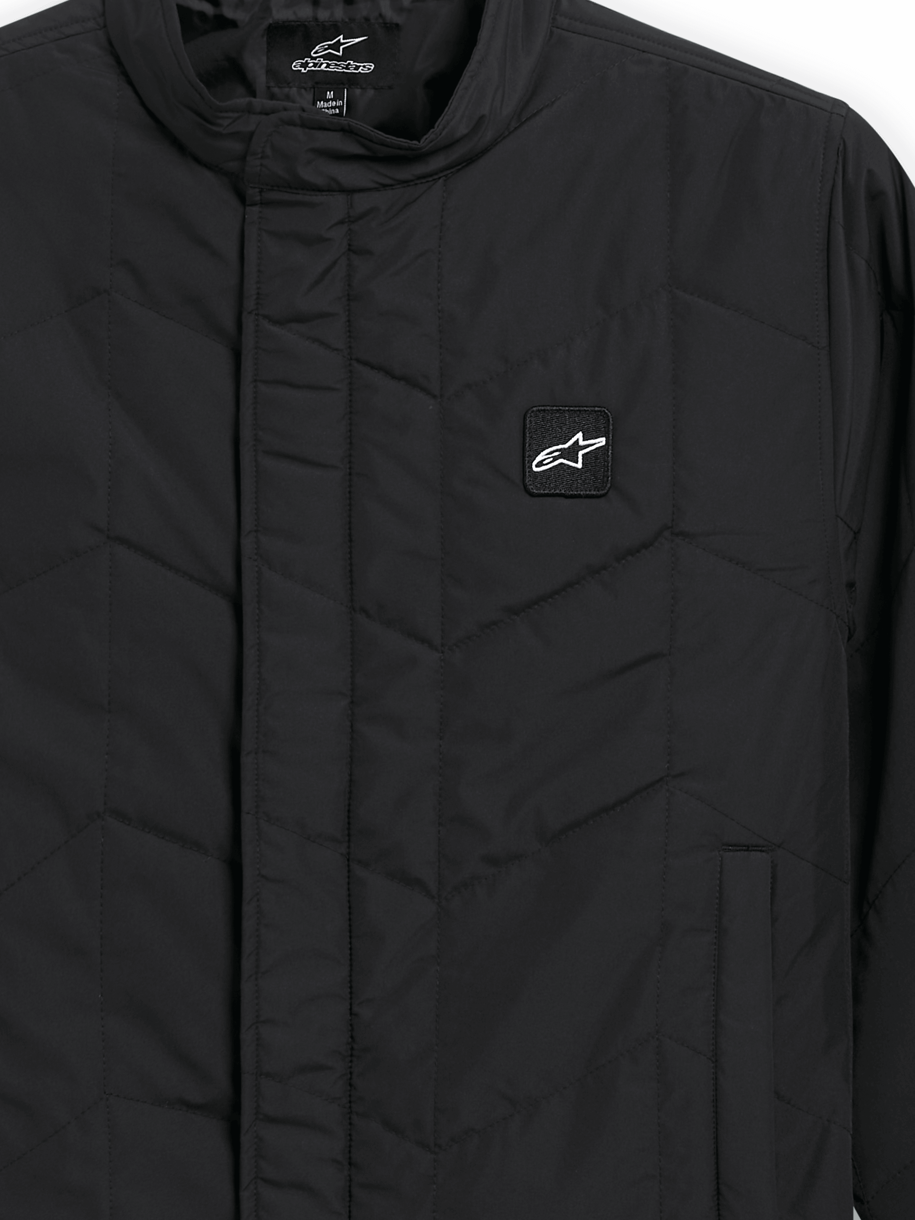 Alpinestars Precedent Jacket, Quilted Sportswear Jacket, Black, close-up view featuring an iconic angled quilt pattern, low track collar, covered front zipper, and small chest logo patch