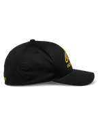 Alpinestars Gild Hat, Sportswear Cap, Black and Gold, side profile view featuring curved bill, structured crown, and gold metallic 3D embroidery on front and side, stretch twill fabric