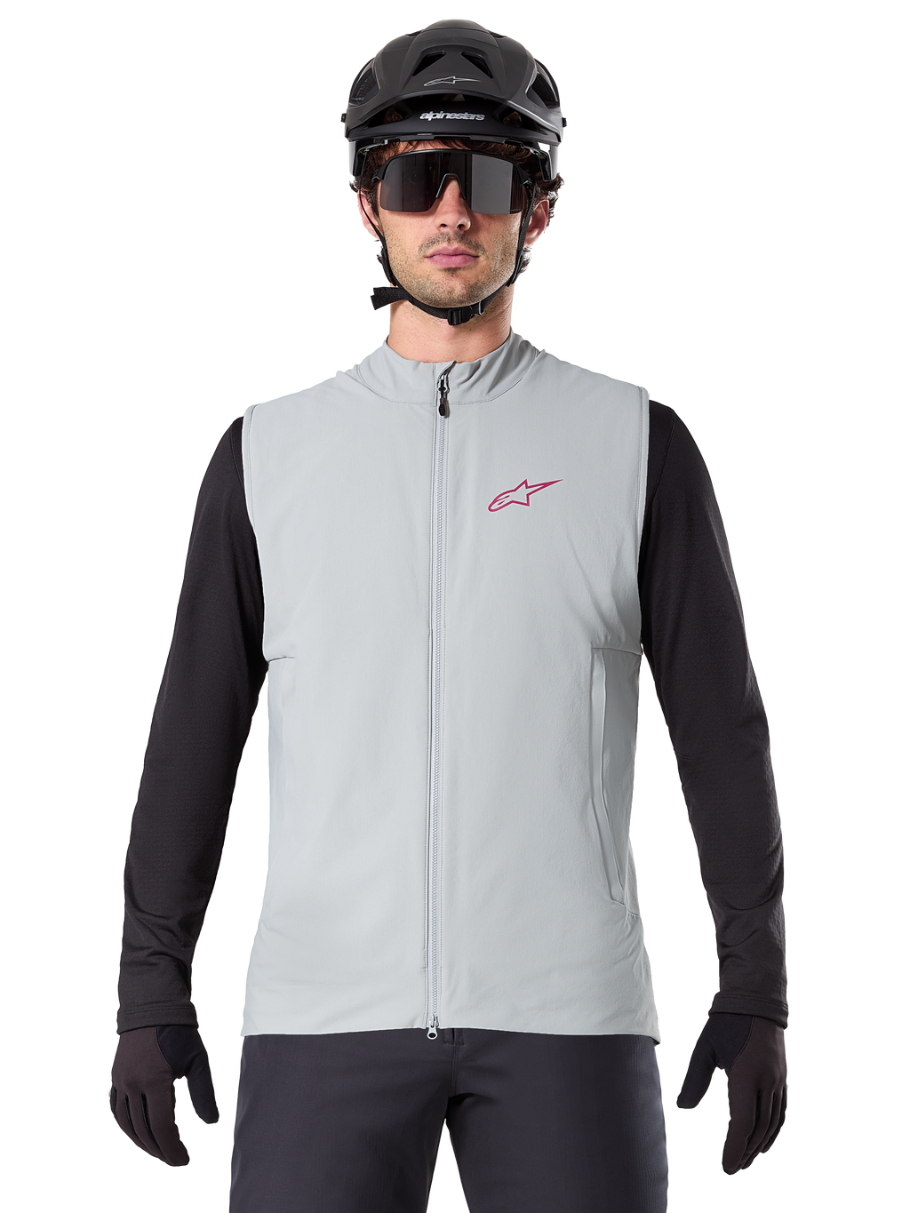 Alpinestars A-Dura Thermal Vest, cykelvest, Titanium Gray, båret med en sort langærmet trøje og sort cykelhjelm, rødt Alpinestars stjerne-logo på brystet, letvægts og isoleret til mountainbiking