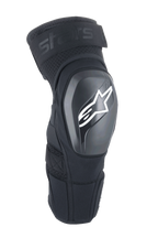 Alpinestars A-Impact Plasma Elite Shield knæbeskyttere, sort med hvidt stjerne-logo, hård ydre TPU-skal, mesh-stof med justerbar rem foroven, forbuet ergonomisk design, MTB- og off-road-beskyttelse