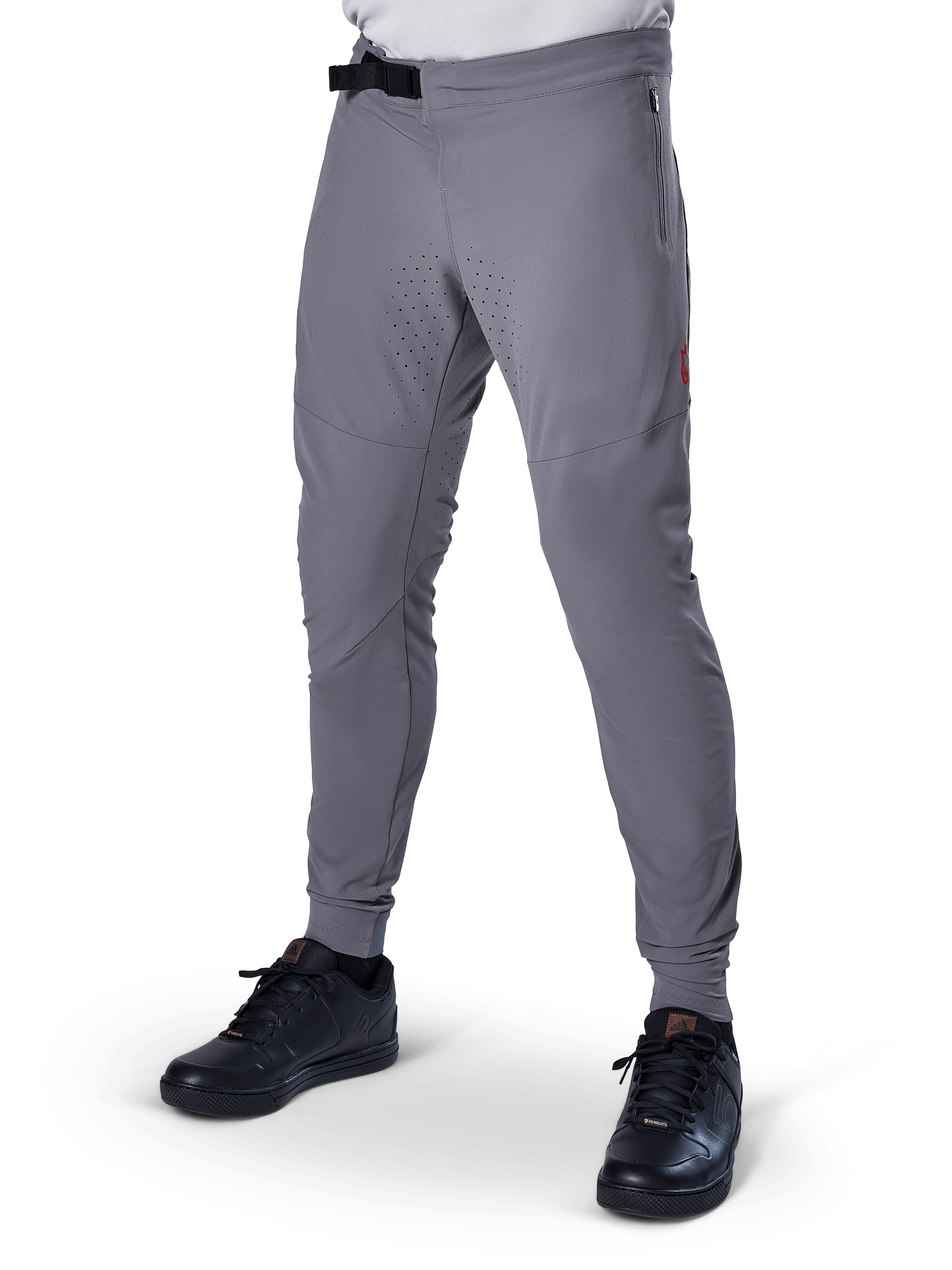 Alpinestars A-Aria Elite bukser, mørkegrå MTB-bukser, laserperforerede paneler på lårene, sort magnetisk spændelukning, lynlåslomme, rød logodetalje, tætsiddende performance-pasform, vist med sorte sko
