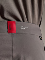 Alpinestars A-Dura Elite bukser, MTB bukser, mørkegrå, nærbillede af linningen med et rødt ASTARS-mærke og hvidt DURA-logo, tekstureret Cordura-stof og eksklusive brandingdetaljer
