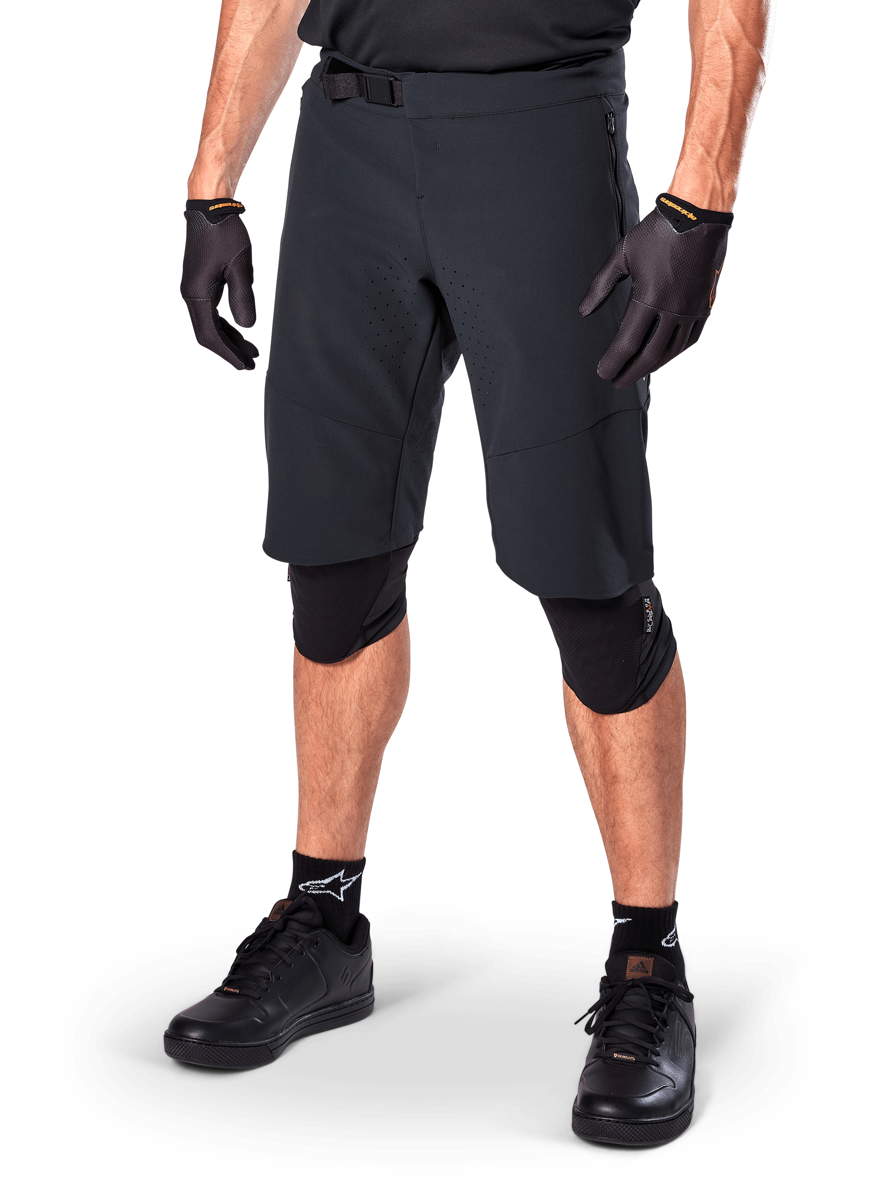 Alpinestars A-Aria Elite Shorts, Black Cycling Shorts, worn with matching black gloves and knee guards, featuring a magnetic buckle and laser-cut perforations, sleek design for off-road mountain biking