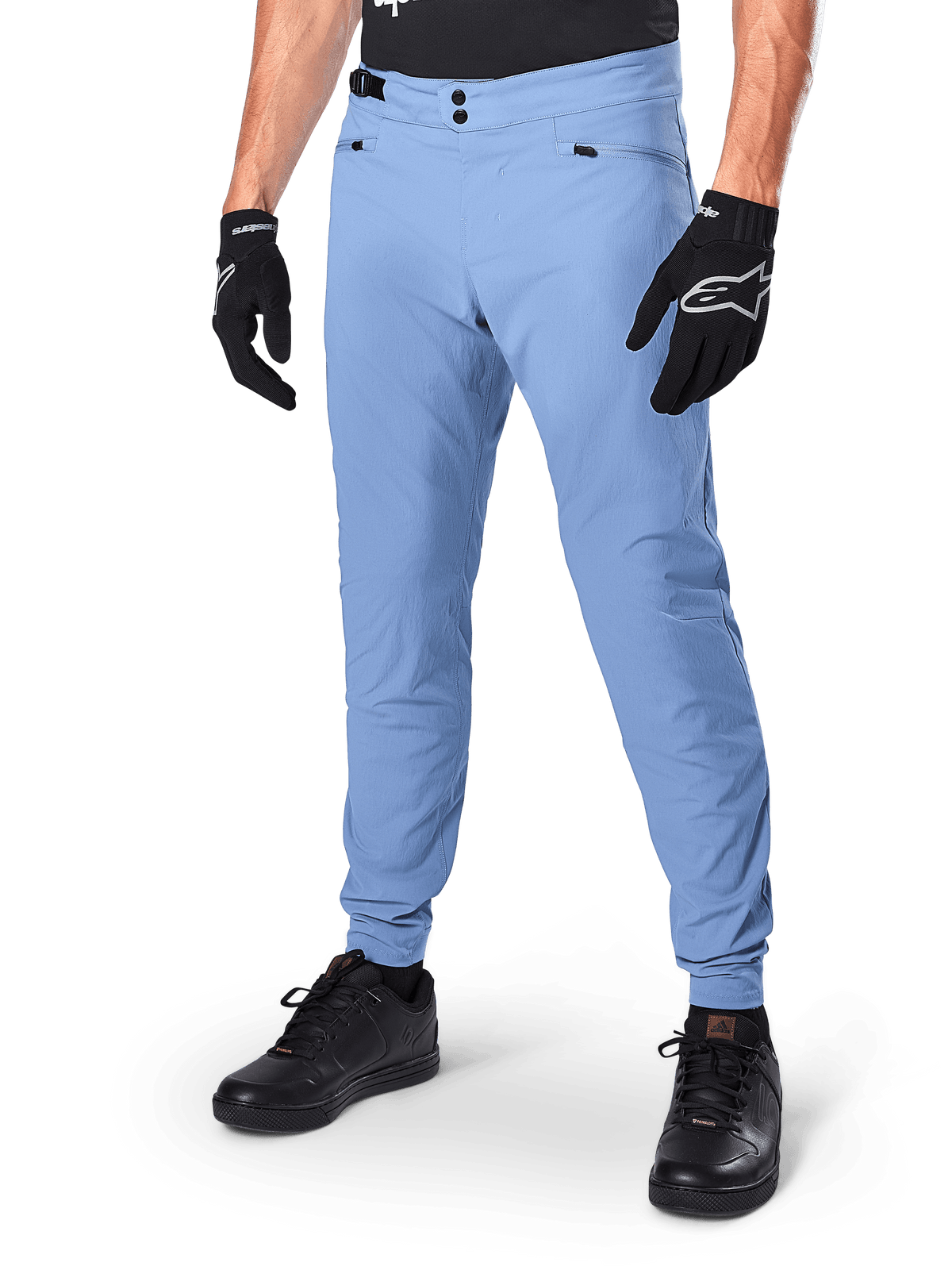 Alpinestars A-Dura Pants, Infinity Blue MTB Cycling Pants, featuring double snap front closure and zippered pockets, worn with black gloves and black shoes, durable 2-way stretch textile for off-road riding