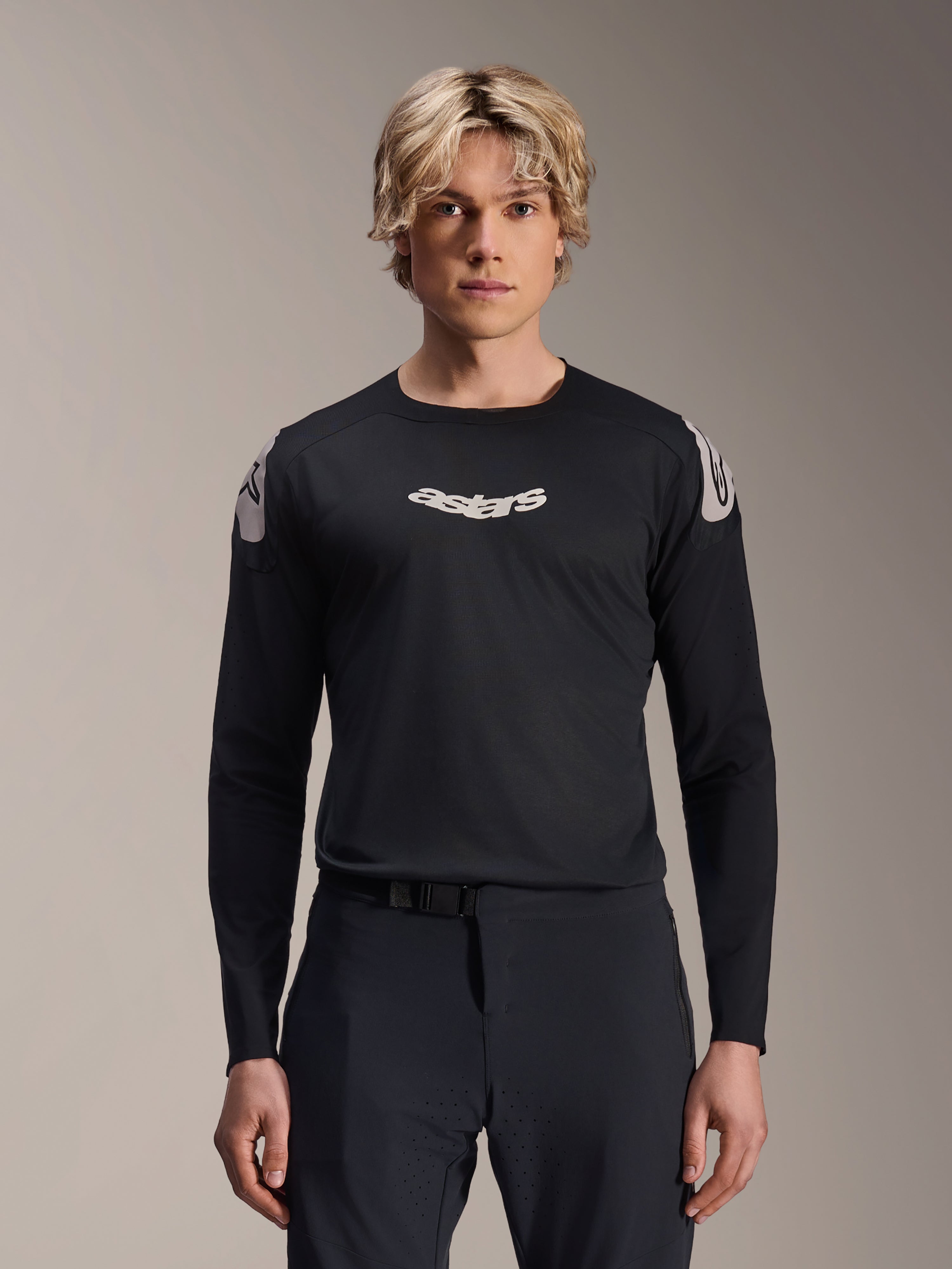 Alpinestars A-Aria Polartec Elite Jersey, Long Sleeve MTB Jersey, Black, featuring white 'astars' chest logo and white shoulder graphics, performance cycling gear worn by a model