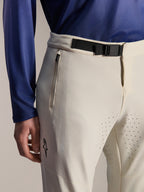 Alpinestars A-Aria Elite Pants, Mountain Bike Pants, Ecru, close-up featuring a black magnetic buckle waist closure, zippered pocket, and laser-cut ventilation holes, performance off-road cycling gear.