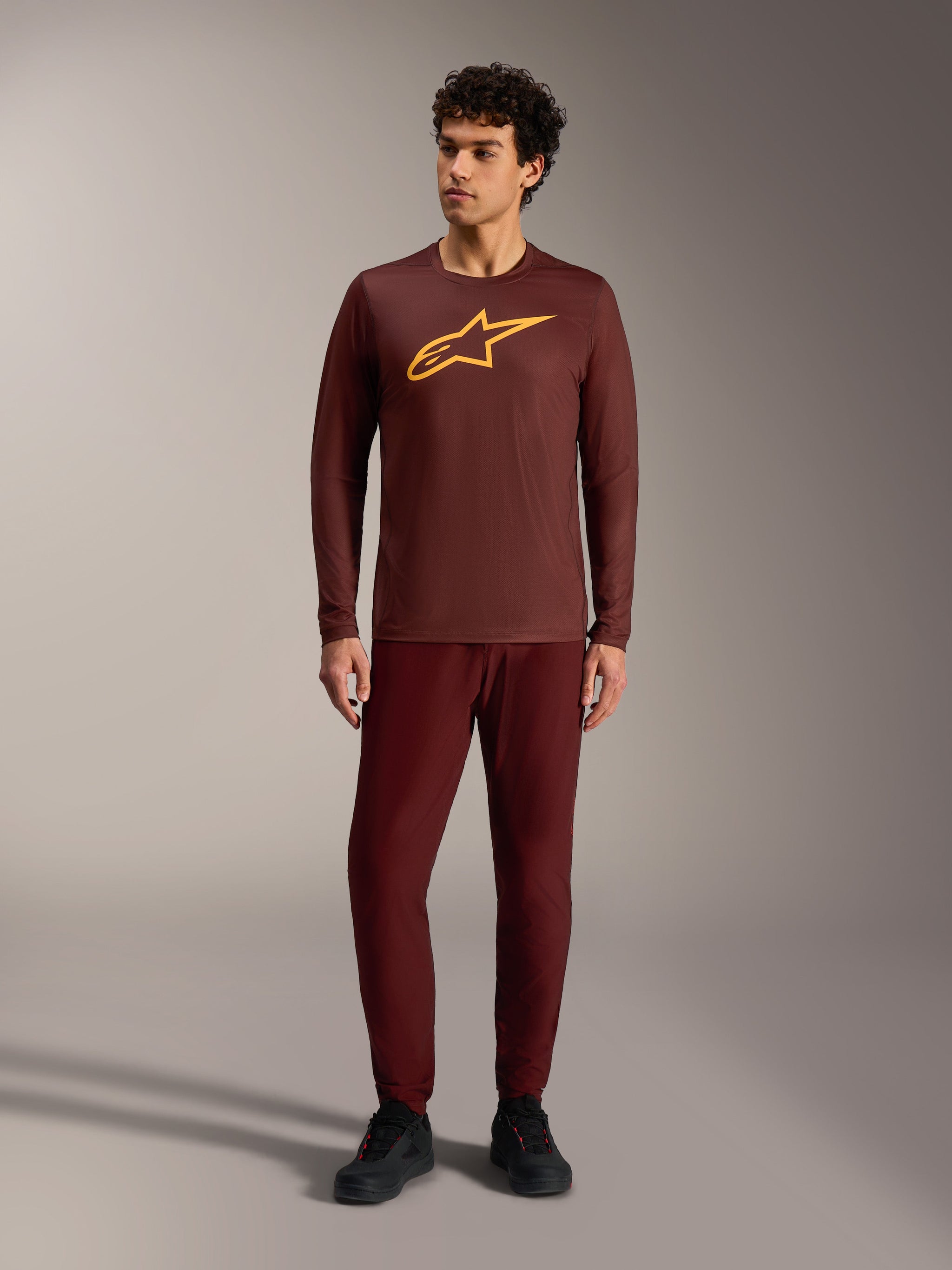 A-Dura Ride Long Sleeve Jersey in Bordeaux with a yellow Alpinestars logo, paired with matching pants for MTB trail riding.