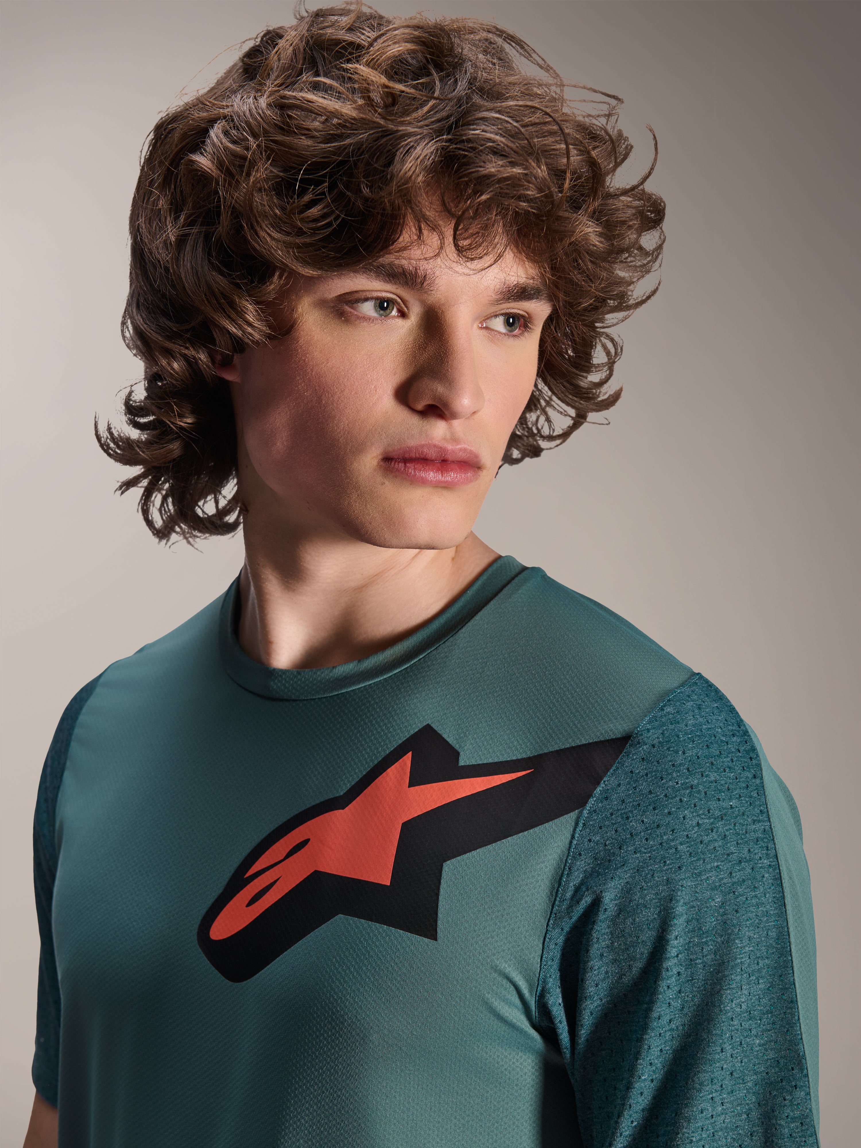 Alpinestars A-Dura Lipan jersey, kortærmet MTB-trøje, Silver Pine, fremtrædende rødt og sort Astars-logo på brystet, teksturerede jacquard-ærmer, tæt portræt af model iført teknisk cykeltøj