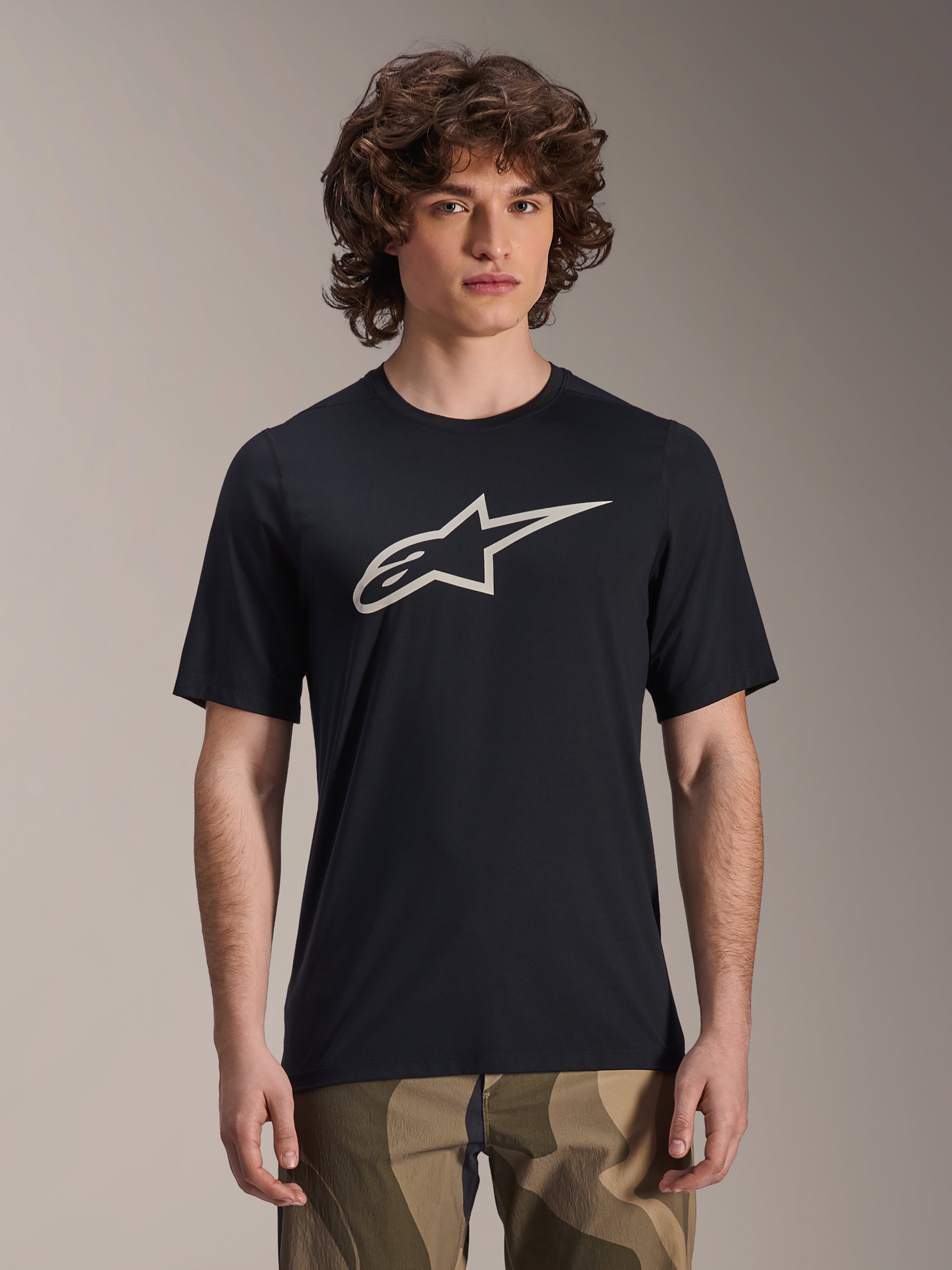 Alpinestars A-Dura Astar Jersey, Short Sleeve MTB Jersey, Black with white star logo, worn with camouflage pants, casual mountain biking apparel, technical moisture-wicking fabric