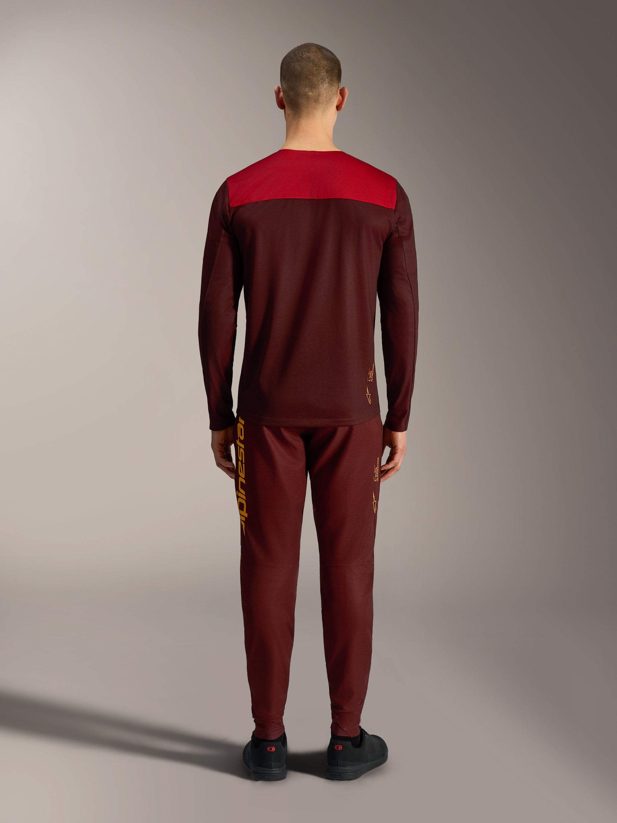 Alpinestars A-Dura Elite trøje 2.0 i bordeaux, set bagfra med rødt skulderpanel, teknisk MTB-beklædning.