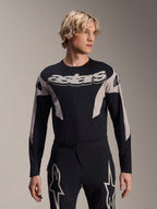 Alpinestars A-Supra Melt Jersey Long Sleeve, MTB Mountain Bike Jersey, Black and Gray, featuring 'astars' graphic across the chest and patterned sleeves, worn with matching performance pants