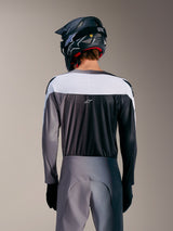 Alpinestars A-Supra Elite trøje i Faded Gray, set bagfra med hvidt øvre panel, mikroperforeret stof og ASTARS-logo.