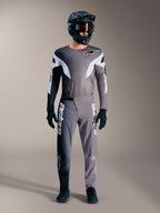 Alpinestars A-Supra Elite MTB-udstyr i falmet grå, med performance-trøje og bukser med markante hvide logoer.