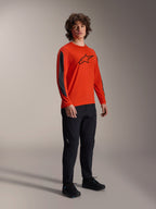 Alpinestars A-Dura Insert Astar langærmet trøje, Spicy Orange med sort Astar-logo på brystet og mørkegrå ærmeindsatser, båret med sorte bukser, professionelt MTB-cykeltøj