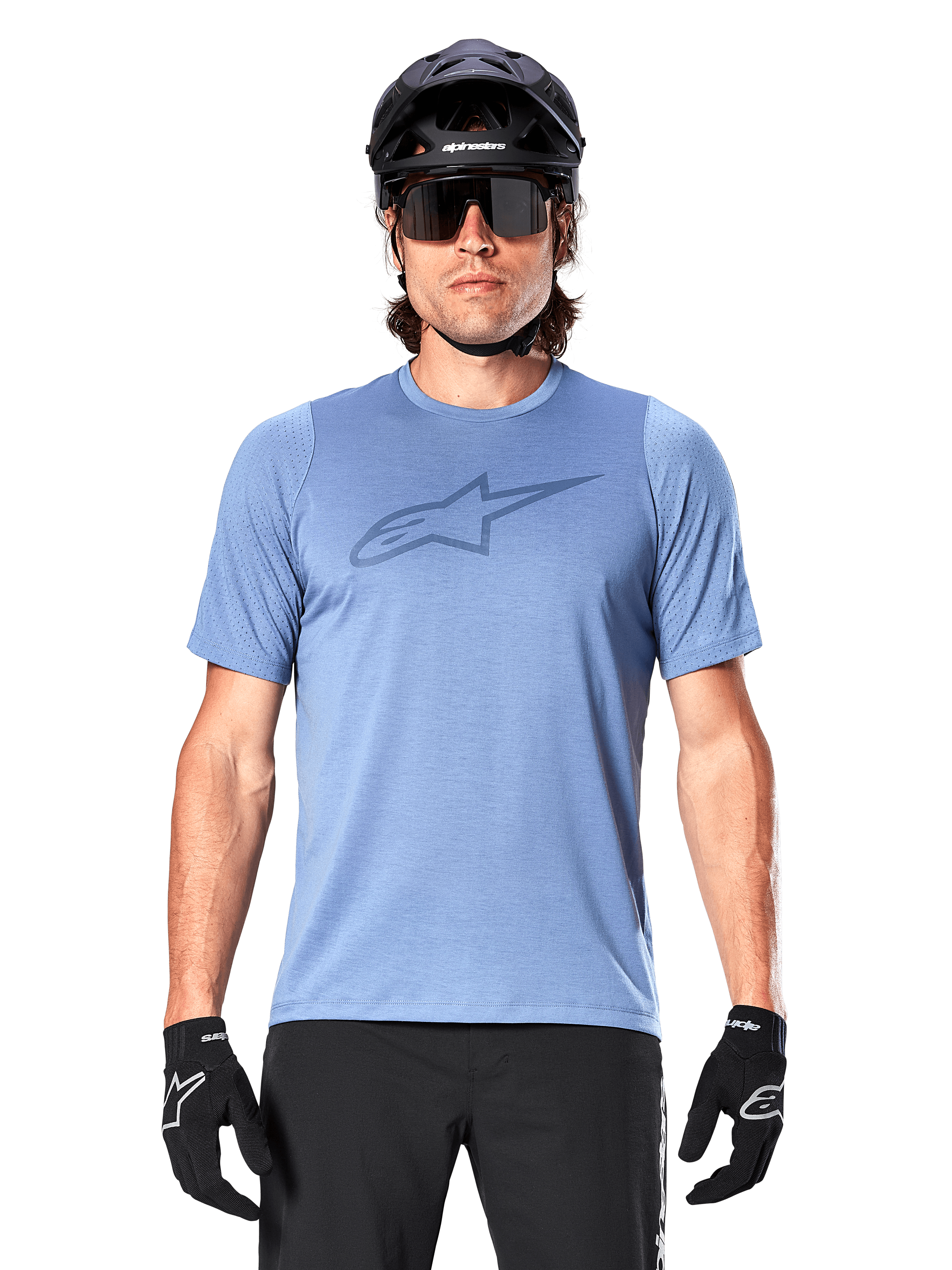Male mountain biker wearing Alpinestars A-Dura Dri Astar Short Sleeve Jersey in Infinity Blue, featuring a subtle chest logo and mesh panels, paired with a black helmet, sunglasses, and black gloves for a technical cycling outfit