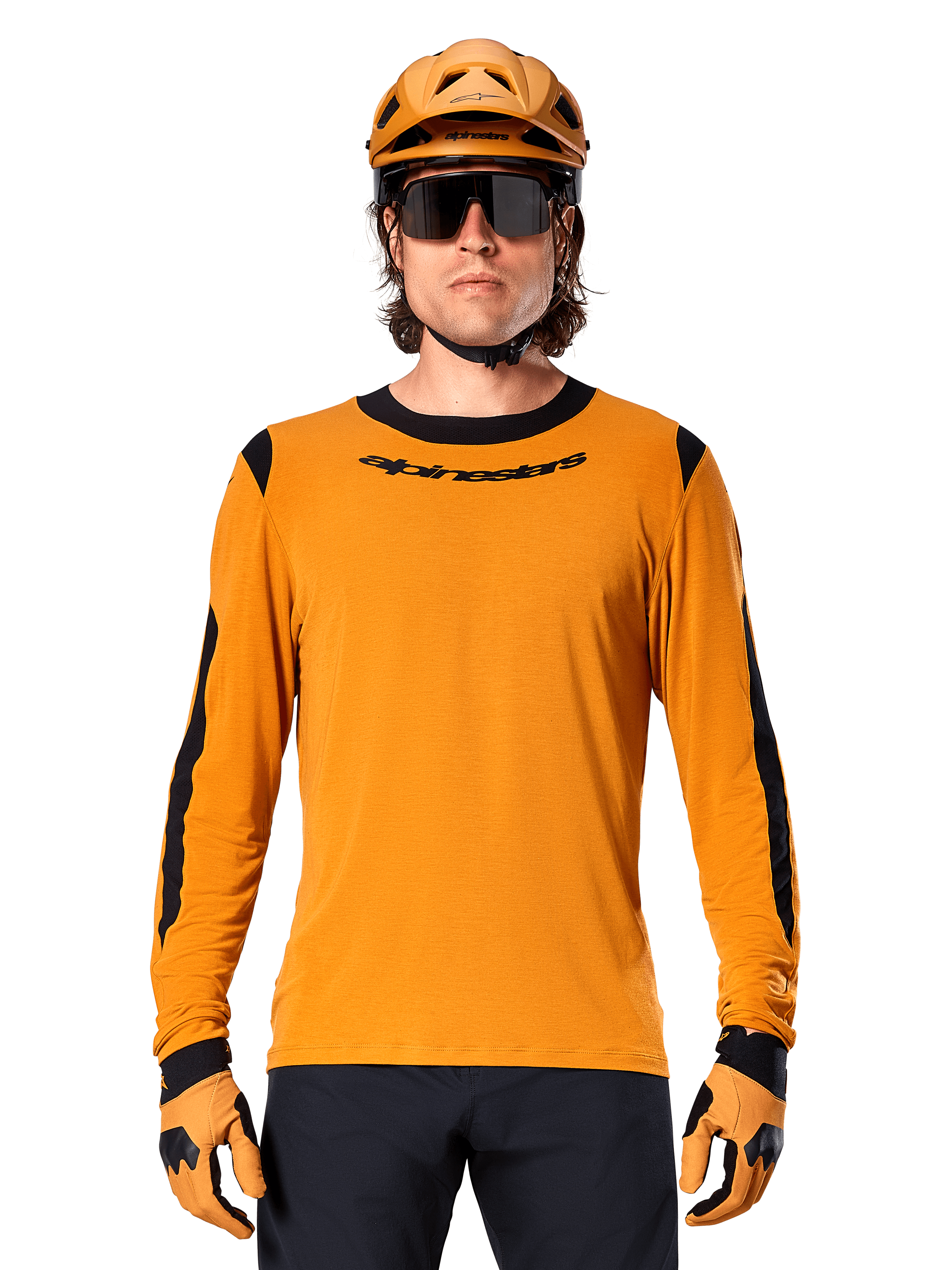 Mandlig model iført Alpinestars A-Dura Dri Wool langærmet trøje i Dark Gold, koordineret med en matchende guld MTB-hjelm og handsker, sorte mesh-paneler på skuldre og ærmer, sort Alpinestars-logo på brystet, mørke solbriller og bukser, teknisk mountainbike-beklædning