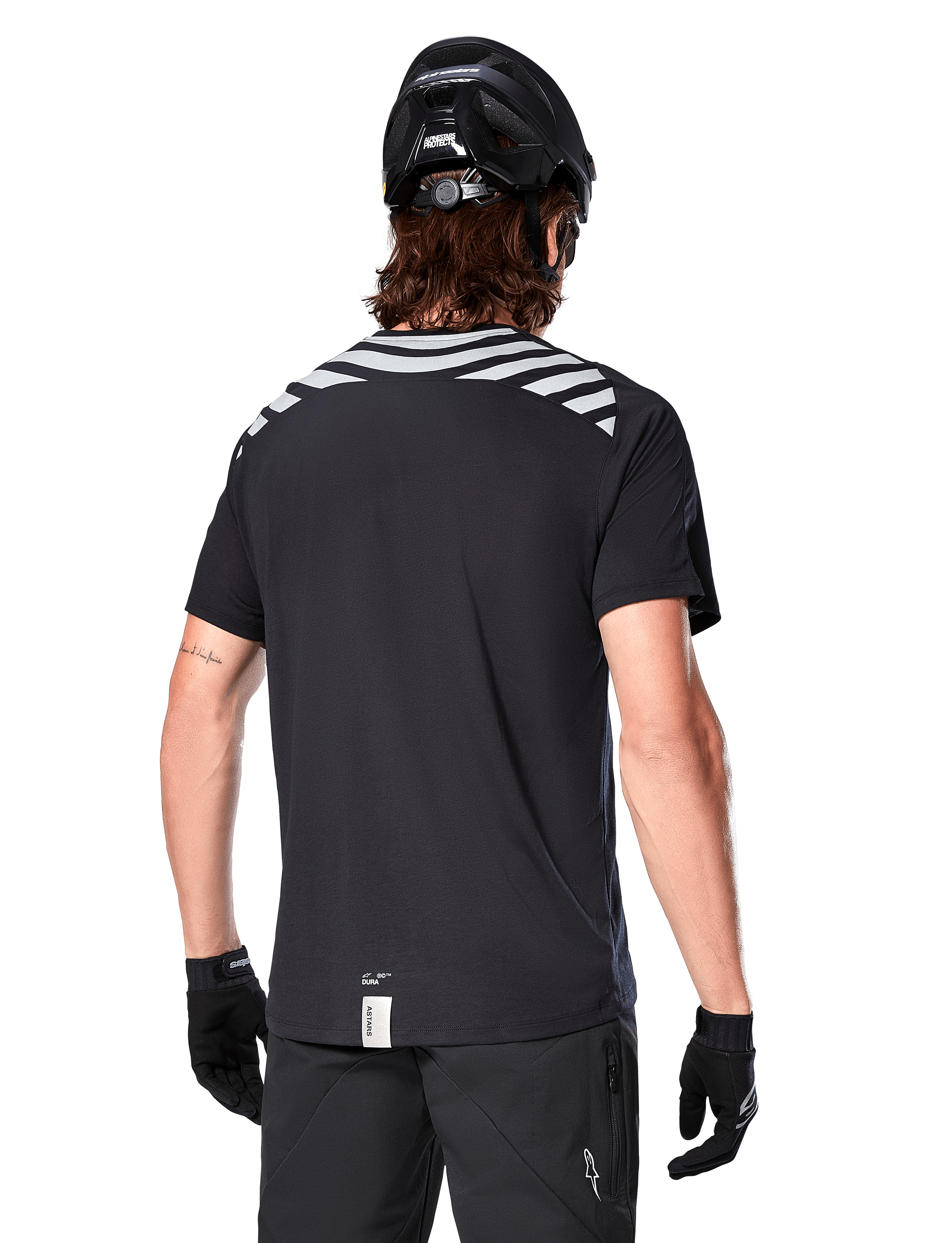 Alpinestars A-Dura Dri Oscar Jersey, Short Sleeve MTB Jersey, Black Reflective, back view on model wearing a cycling helmet and gloves, featuring reflective grey shoulder stripes and a dropped tail, moisture-wicking technical fabric for mountain biking
