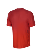Alpinestars Youth A-Dura Rise kortærmet jersey, set bagfra, Spicy Orange, jacquard-vævet tekstur, lille sort Astars-logo på siden, forlænget rygstykke til mountainbike-brug.