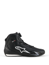 Alpinestars Celer Shoes, Motorcycle Riding Shoes, Black and White, lateral side profile with large white star logo, Rotor Closure System dial for fit adjustment, and sleek sport-performance silhouette
