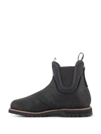 Alpinestars Turnstone sko, sort motorcykelstøvle i Chelsea-stil, profilvisning fra siden, fremstillet af 1,5 mm bovint læder med elastiske ankelpaneler og træksløjfer foran og bagpå.