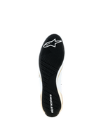 Alpinestars Supertech K Shoes - FIA, bottom view showing the black ultra-thin rubber outsole, asymmetric tread pattern for grip, white Alpinestars logo and wordmark, gold and white side accents, specialized karting footwear