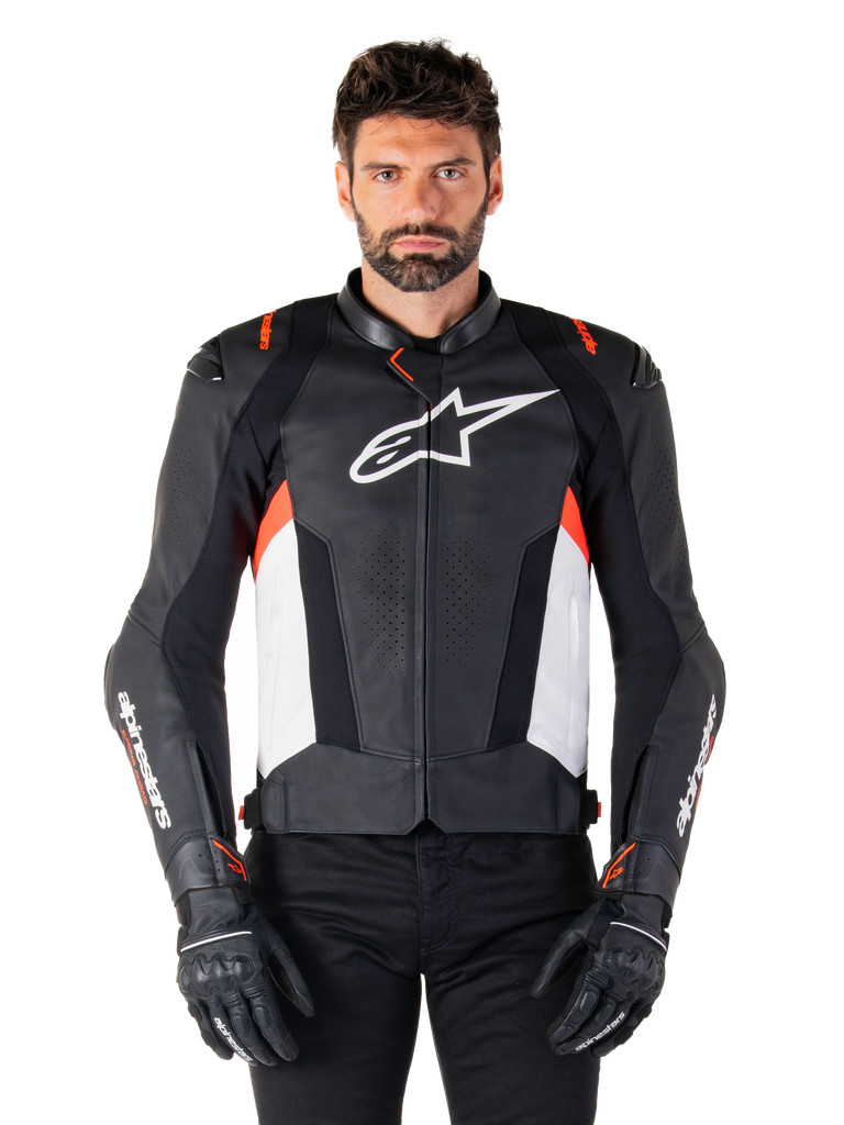 Alpinestars Missile V3 Leather Jacket, Black White and Red Fluo, premium racing sport jacket with bovine leather, featuring white chest logo and Alpinestars branding on sleeves, worn with black motorcycle gloves and pants
