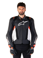 Alpinestars Missile V3 Airflow læderjakke, motorcykeljakke til racing, sort og hvid med røde fluo-detaljer, perforerede ventilationspaneler, hvidt stjerne-logo på brystet, bæres med sorte og røde handsker, premium læderkonstruktion
