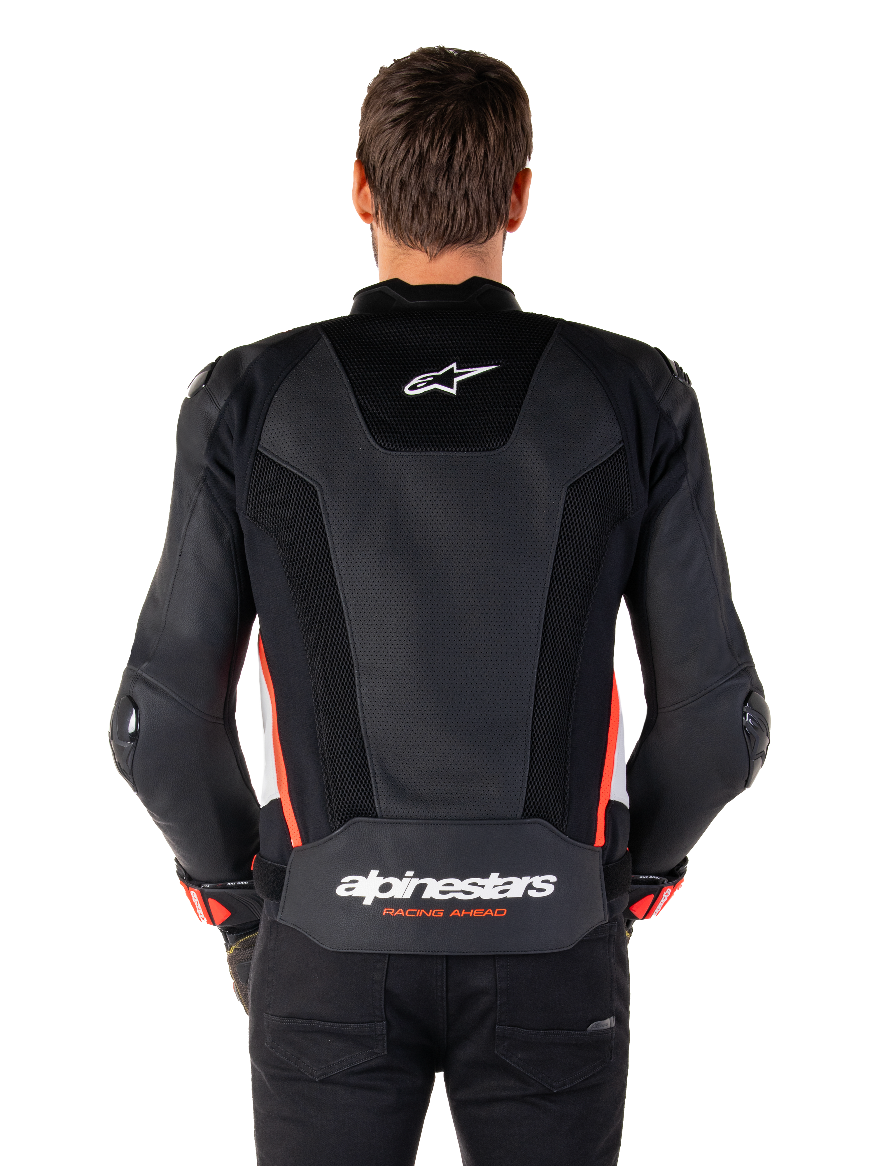 Set bagfra af en person iført Alpinestars Missile V3 Airflow læderjakke i Black White Red Fluo, med omfattende perforerede læderpaneler til ventilation, et lille Alpinestars-logo på den øverste del af ryggen og tydelig 'alpinestars RACING AHEAD'-branding nederst på taljen.
