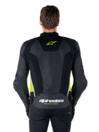 Alpinestars Missile V3 Airflow læderjakke, set bagfra, sort med fluo-gule og hvide detaljer, omfattende perforerede læderpaneler til køling, Alpinestars-branding på øvre og nedre ryg, racing-inspireret motorcykel sportsjakke