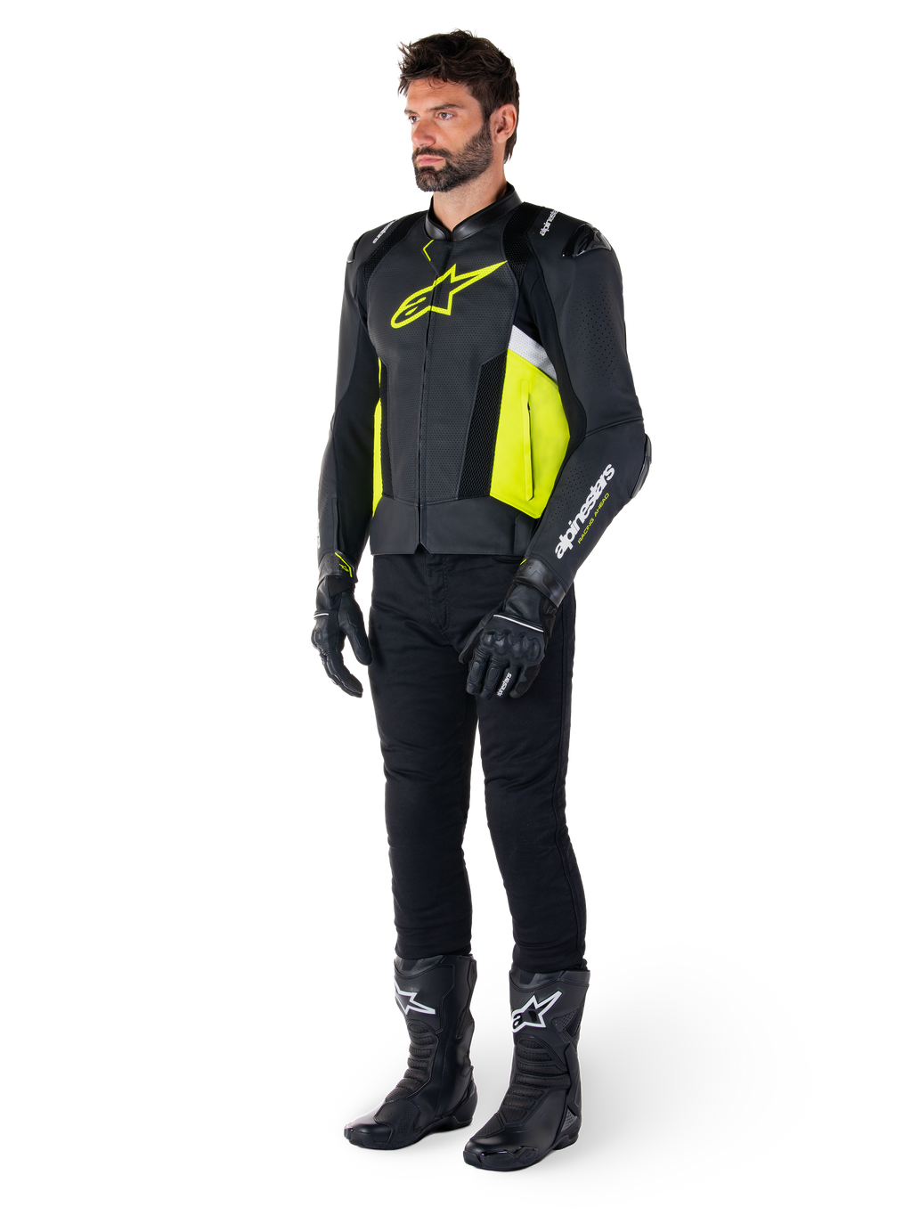Mandlig model iført Alpinestars Missile V3 Airflow læderjakken i sort, gul fluo og hvid, stylet med sorte kørehandsker, bukser og støvler, der fremviser det perforerede læderdesign og den racing-inspirerede æstetik.