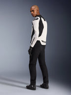 Alpinestars GP Force V2 Leather Jacket, White and Black, back profile view worn by a model, featuring white bovine leather with black stretch panels, Alpinestars logos on the shoulder and back, paired with black riding pants and boots.