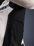 Close-up detail of the Alpinestars GP Force V2 Leather Jacket in White and Black, highlighting the zippered side ventilation and high-resistance stretch fabric panels for enhanced airflow and rider mobility.