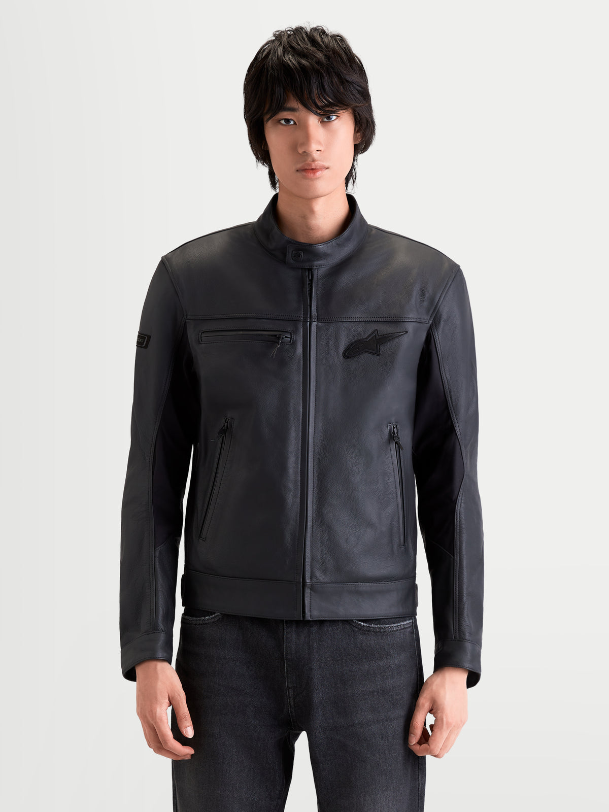 Alpinestars Maver-X Leather Jacket, men's urban contemporary motorcycle leather jacket in black, front view on a model wearing protective riding gear, premium bovine leather construction with stretch inserts