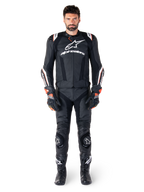Mandlig motorcyklist iført Alpinestars Missile V3 Ignition læderjakke i sort, kombineret med matchende læderbukser, handsker og støvler, med hvid Alpinestars-branding og røde detaljer, designet til professionel racing-ydeevne.
