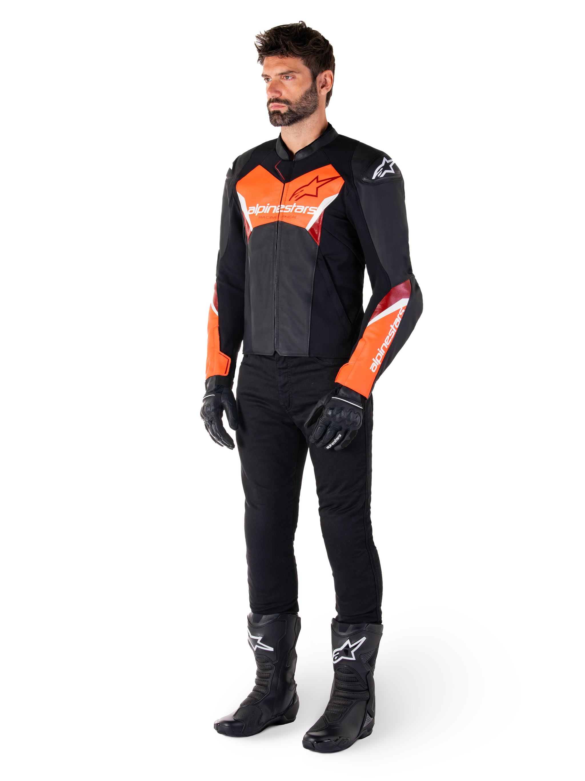 Male rider wearing the Alpinestars Faster V3 Leather Jacket in Black and Red Fluo, paired with black riding pants, gloves, and boots. The jacket features a race-derived silhouette with bold fluorescent red accents on the chest and sleeves, white Alpinestars branding, and a premium leather construction.