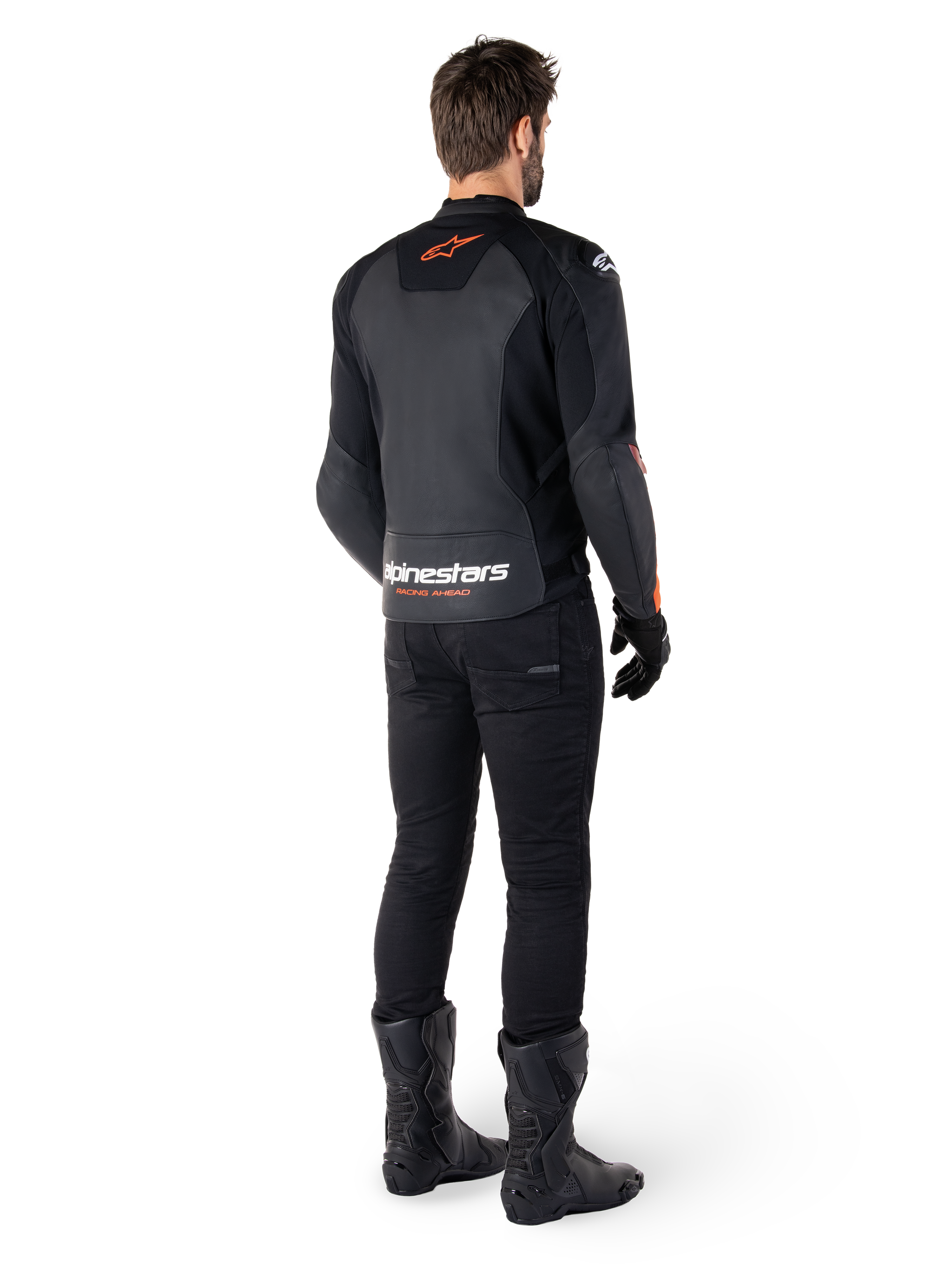 Alpinestars Faster V3 Leather Jacket, Sport Motorcycle Jacket, Black and Red Fluo, rear view worn with black pants and black boots, featuring 'alpinestars RACING AHEAD' text on the lower back and a small red star logo, sleek sport-fit leather construction