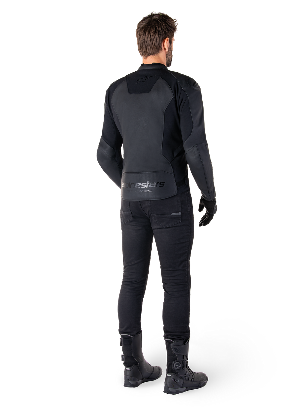 Alpinestars Faster V3 læderjakke, sort, set bagfra på en motorcyklist, med premium læderpaneler og præget Alpinestars-branding, kombineret med sorte kørebukser og støvler for et komplet sportsmotorcykel-look.