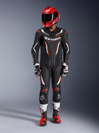 Alpinestars GP Force V2 Leather Suit - 1Piece, Black White and Red Fluo, worn with a red racing helmet, black and white gloves, and red and black boots, featuring perforated leather panels and Alpinestars branding, professional motorcycle racing gear