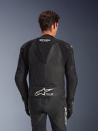 Alpinestars GP Force V2 læderdragt, 2-delt, sort, set bagfra på kører, med perforerede læderpaneler, aerodynamisk rygpukkel med GP Force-branding og hvidt Alpinestars-logo med Tech-Air Ready-tekst på lænden.