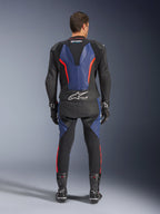 Alpinestars GP Force V2 Leather Suit 2-Piece, Rear View, Black Blue and Red Fluo, featuring blue leather panels on the back and legs with fluorescent red accents, Tech-Air Ready branding on the lower back, worn with black racing gloves and boots.