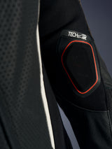 Alpinestars Stella GP-R7 1-Piece Leather Suit, Black, detailed view of the Tech-Air airbag compatibility indicator on the sleeve, featuring a red-contoured mesh panel and perforated leather construction